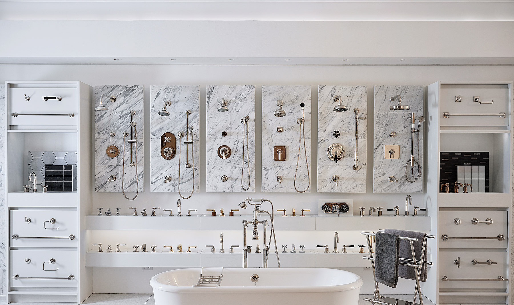 Waterworks showroom wall of shower fittings on marble panels